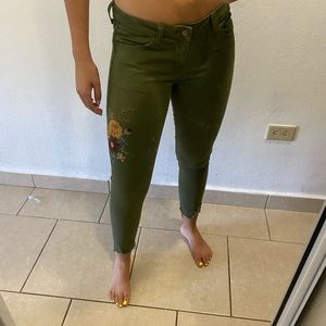 Hunter green jeans with embroidered flowers